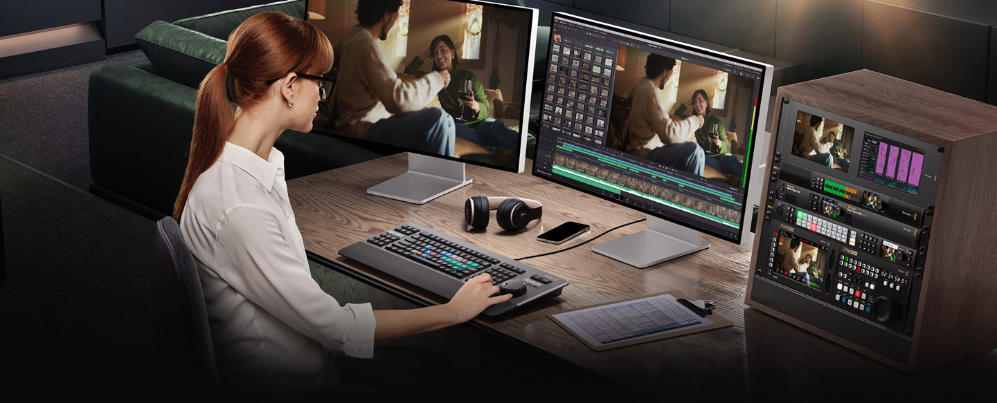 Editor using DaVinci Resolve Editor Keyboard at a dual-monitor workstation